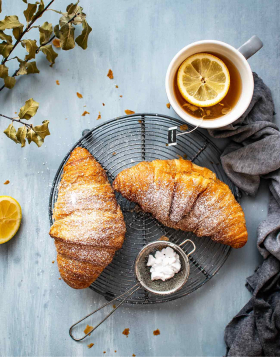Tasty croissant and tea for perfect breakfast Tasty croissant and tea for perfect breakfast